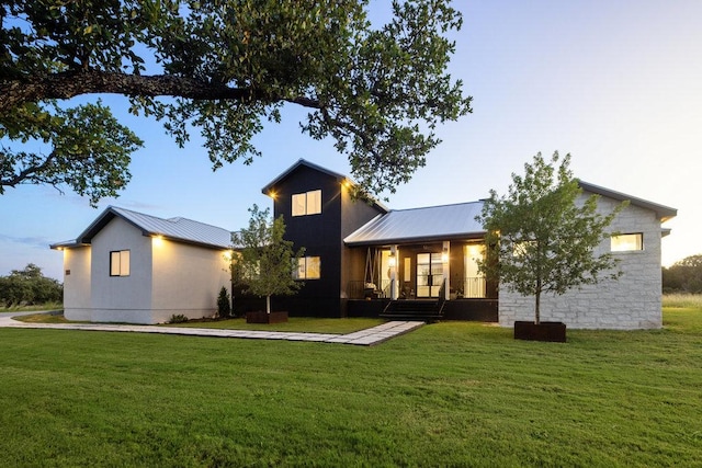 150 Wandering Oak Cir, Burnet, TX 78611 - rear view of property with a yard and a metal roof