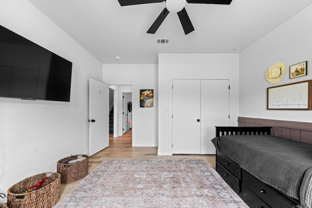 150 Wandering Oak Cir, Burnet, TX 78611 - bedroom with wood finished floors, a ceiling fan, and a closet