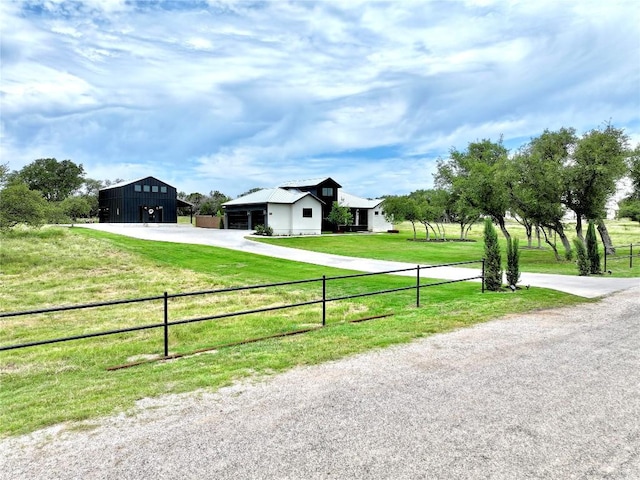 150 Wandering Oak Cir, Burnet, TX 78611 - modern farmhouse featuring an outdoor structure, a pole building, and driveway