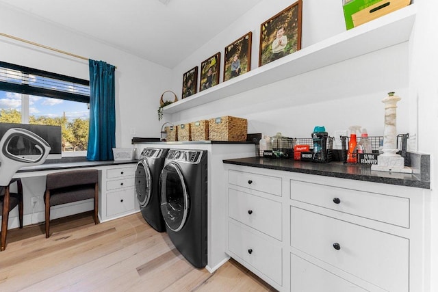150 Wandering Oak Cir, Burnet, TX 78611 - laundry room with washer and clothes dryer and light wood-style flooring