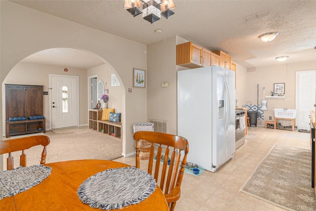 926 Zwicke St, Seguin, TX 78155 - dining space featuring arched walkways, a textured ceiling, and a chandelier