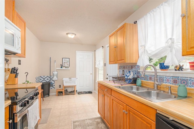 926 Zwicke St, Seguin, TX 78155 - kitchen featuring stainless steel electric range, white microwave, light floors, dishwashing machine, and light countertops