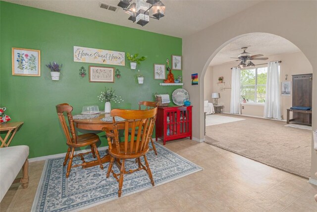 926 Zwicke St, Seguin, TX 78155 - dining space featuring arched walkways, a chandelier, a ceiling fan, and carpet
