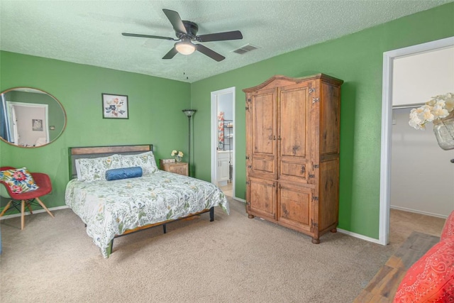 926 Zwicke St, Seguin, TX 78155 - carpeted bedroom featuring a spacious closet, a textured ceiling, a ceiling fan, and a closet