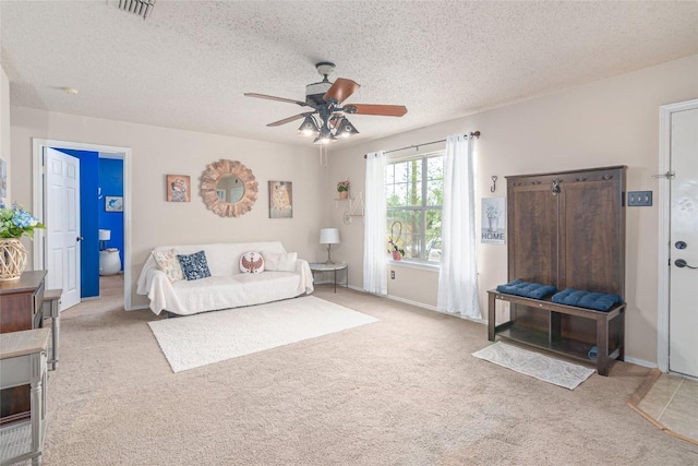 926 Zwicke St, Seguin, TX 78155 - living area featuring ceiling fan, carpet, and a textured ceiling