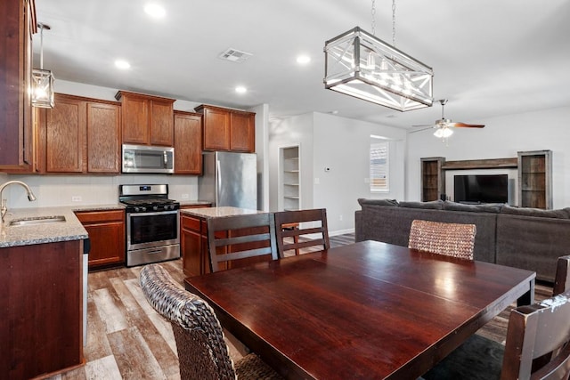 529 Cinnamon Teal Ln, Leander, TX 78641 - dining space with light wood finished floors, ceiling fan, and recessed lighting