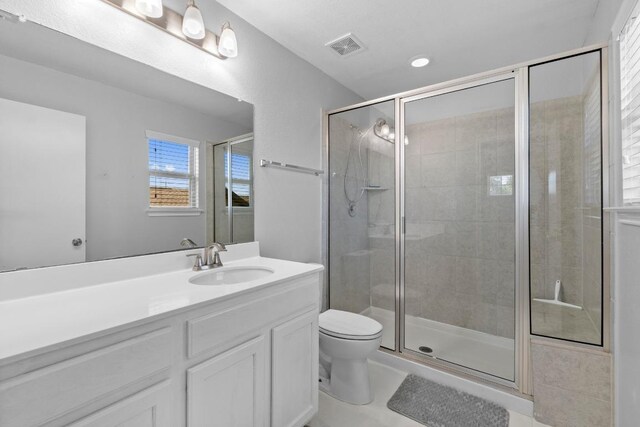 529 Cinnamon Teal Ln, Leander, TX 78641 - bathroom with toilet, vanity, and a shower stall