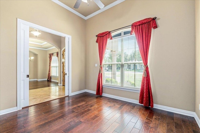 118 NE Verrena Way, Georgetown, TX 78628 - empty room with crown molding, wood-type flooring, a chandelier, baseboards, and arched walkways