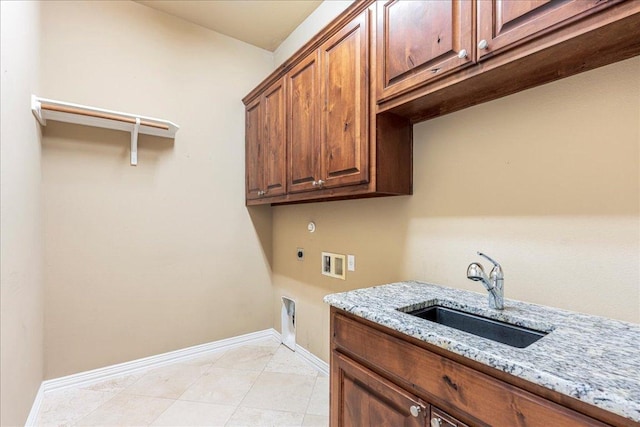 118 NE Verrena Way, Georgetown, TX 78628 - washroom with washer hookup, electric dryer hookup, cabinet space, baseboards, and light tile patterned floors