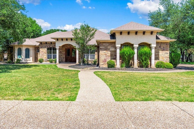 118 NE Verrena Way, Georgetown, TX 78628 - mediterranean / spanish house featuring stone siding, a front yard, and roof with shingles