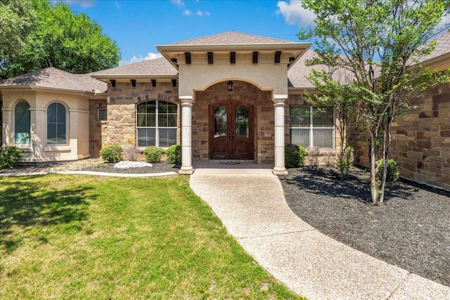 118 NE Verrena Way, Georgetown, TX 78628 - property entrance with stone siding, roof with shingles, a lawn, and french doors