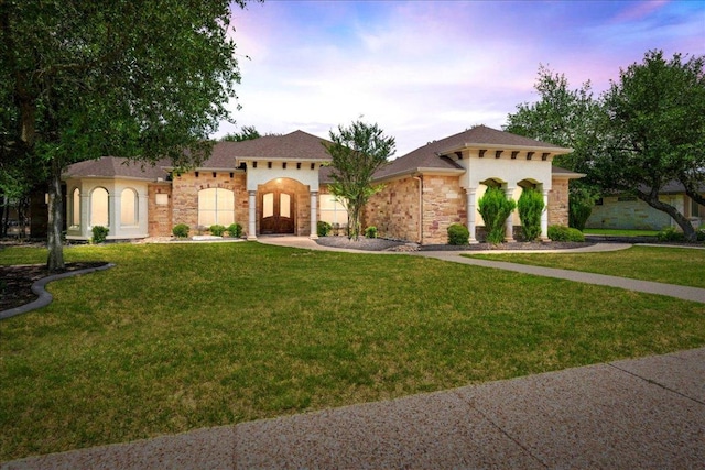 118 NE Verrena Way, Georgetown, TX 78628 - mediterranean / spanish-style home with stucco siding, a yard, french doors, and stone siding