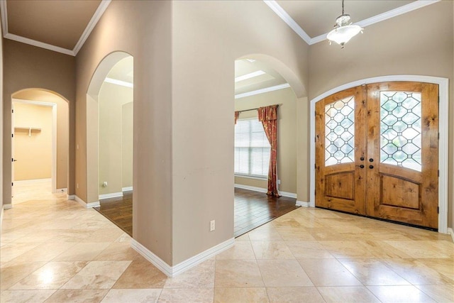 118 NE Verrena Way, Georgetown, TX 78628 - foyer featuring arched walkways, ornamental molding, baseboards, and french doors