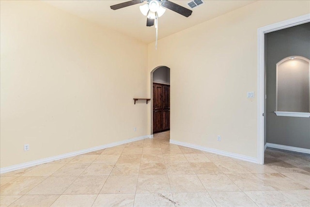 118 NE Verrena Way, Georgetown, TX 78628 - spare room with arched walkways, a ceiling fan, and baseboards