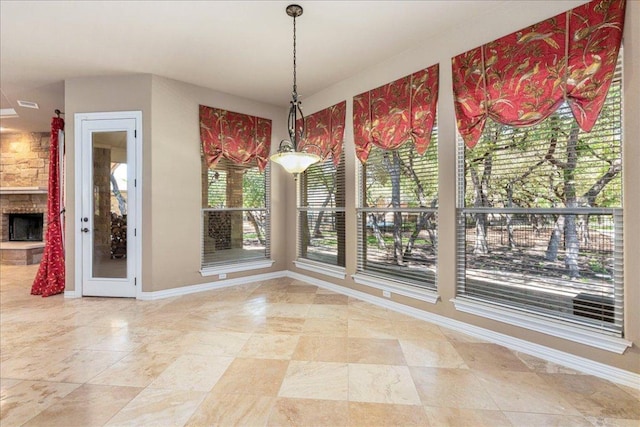 118 NE Verrena Way, Georgetown, TX 78628 - unfurnished dining area featuring baseboards and a fireplace