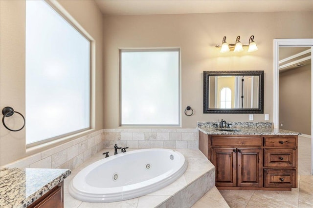 118 NE Verrena Way, Georgetown, TX 78628 - bathroom featuring vanity, a whirlpool tub, and tile patterned floors