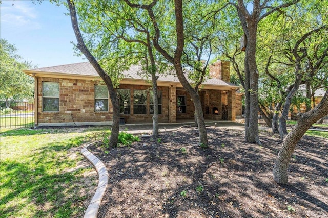 118 NE Verrena Way, Georgetown, TX 78628 - back of property featuring a chimney and stone siding