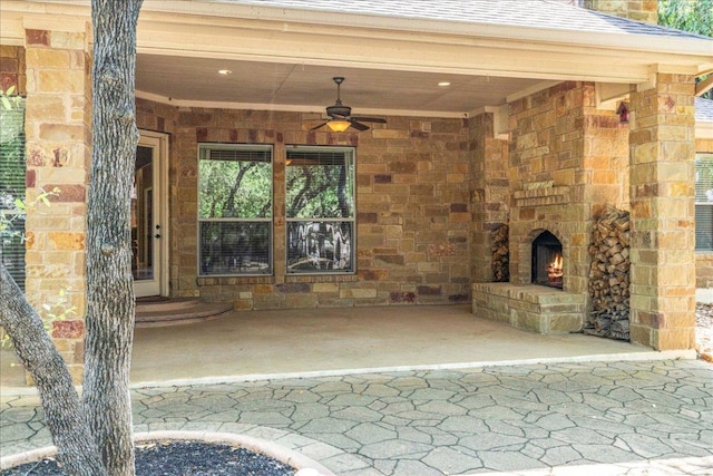 118 NE Verrena Way, Georgetown, TX 78628 - view of patio with a ceiling fan and an outdoor stone fireplace