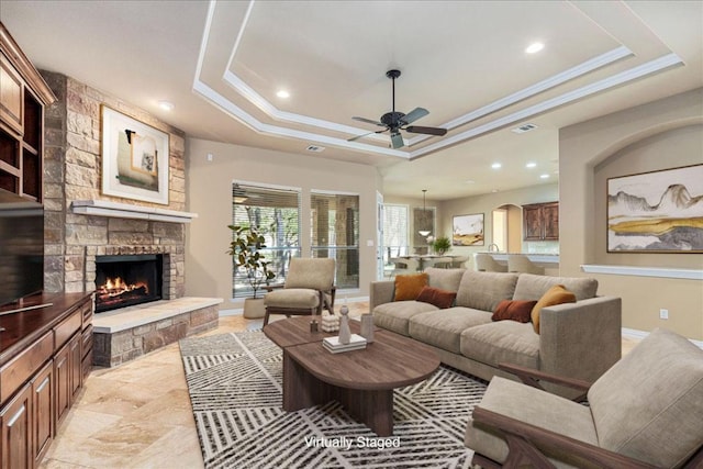 118 NE Verrena Way, Georgetown, TX 78628 - living room with a raised ceiling, ceiling fan, recessed lighting, baseboards, and a stone fireplace