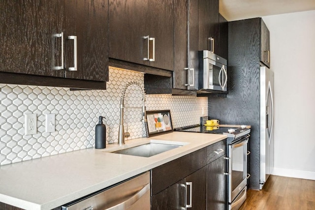 3114 S Congress Ave Unit 304, Austin, TX 78704 - kitchen featuring appliances with stainless steel finishes, light countertops, decorative backsplash, and dark brown cabinets
