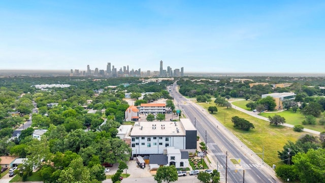 3114 S Congress Ave Unit 304, Austin, TX 78704 - drone / aerial view of skyline, a major roadway, and a tree filled landscape