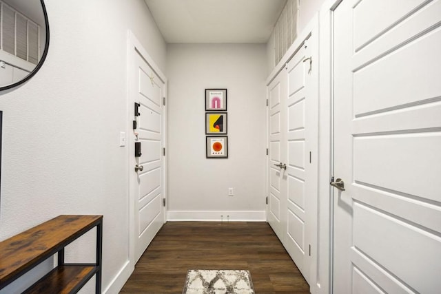 3114 S Congress Ave Unit 304, Austin, TX 78704 - doorway featuring baseboards and dark wood-style flooring