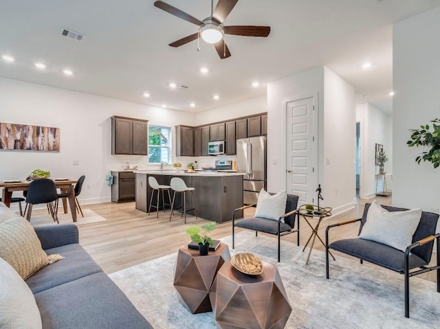 1108 Floradale Dr, Austin, TX 78753 - living area with light wood-style flooring, baseboards, a ceiling fan, and recessed lighting