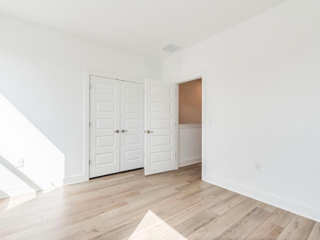 1108 Floradale Dr, Austin, TX 78753 - unfurnished bedroom with light wood-style floors, a closet, and baseboards