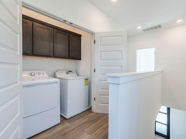 1108 Floradale Dr, Austin, TX 78753 - laundry area featuring cabinet space, washer and dryer, light wood-style flooring, and recessed lighting