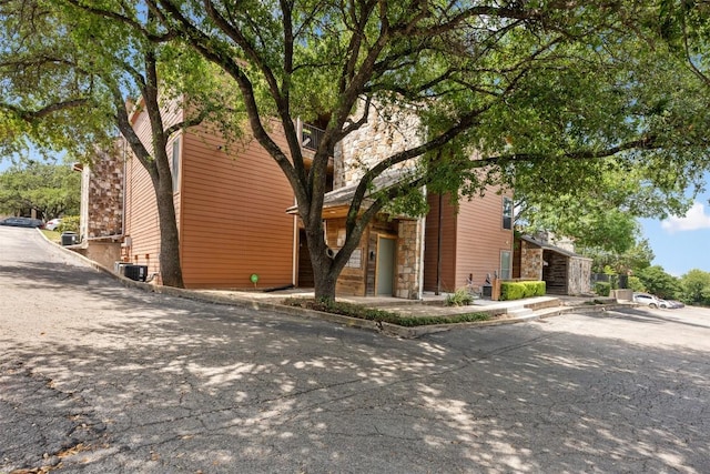 6903 Deatonhill Dr Unit 15, Austin, TX 78745 - view of side of property with stone siding and central air condition unit