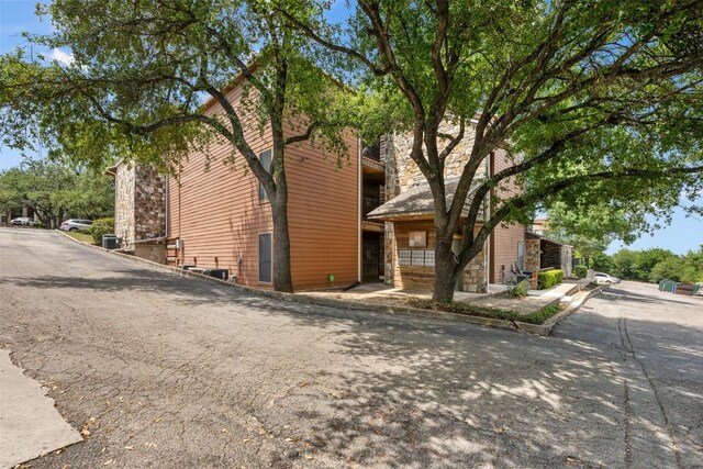 6903 Deatonhill Dr Unit 15, Austin, TX 78745 - view of side of property featuring stone siding