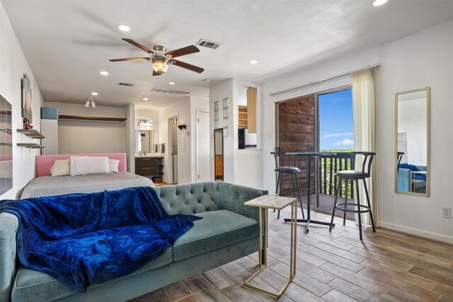 6903 Deatonhill Dr Unit 15, Austin, TX 78745 - bedroom with wood finished floors, recessed lighting, and ensuite bath