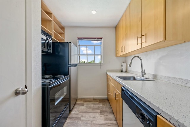 6903 Deatonhill Dr Unit 15, Austin, TX 78745 - kitchen with a sink, black appliances, light wood-style floors, light countertops, and baseboards