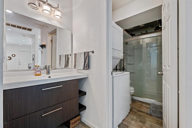 6903 Deatonhill Dr Unit 15, Austin, TX 78745 - bathroom featuring vanity, a shower stall, toilet, wood finished floors, and baseboards