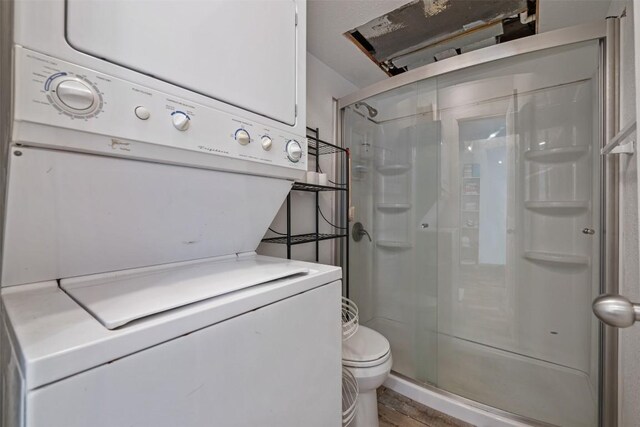 6903 Deatonhill Dr Unit 15, Austin, TX 78745 - full bath with estacked washer and dryer, a stall shower, and toilet