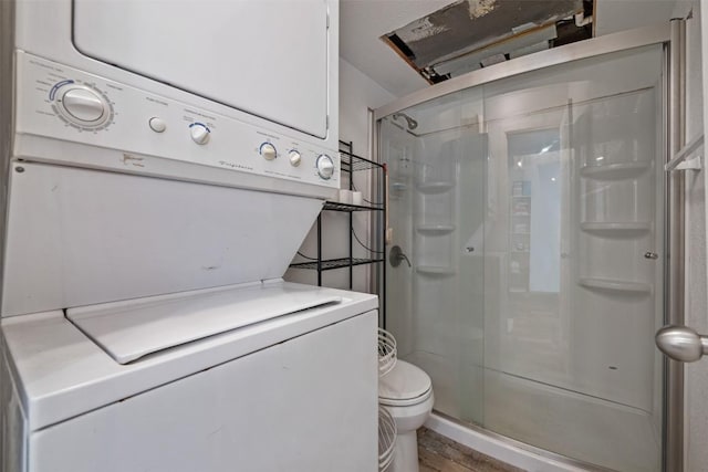 6903 Deatonhill Dr Unit 15, Austin, TX 78745 - full bathroom featuring estacked washer and dryer, a shower stall, and wood finished floors