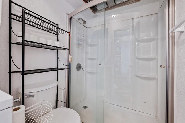 6903 Deatonhill Dr Unit 15, Austin, TX 78745 - full bathroom with a stall shower and a textured wall
