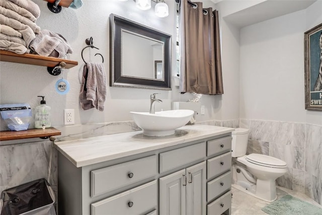 20502 Greeley Cv, Lago Vista, TX 78645 - bathroom featuring vanity, wainscoting, and tile walls