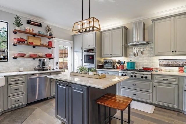 20502 Greeley Cv, Lago Vista, TX 78645 - kitchen with appliances with stainless steel finishes, wall chimney exhaust hood, gray cabinets, plenty of natural light, and ornamental molding