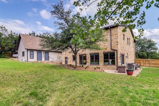 20502 Greeley Cv, Lago Vista, TX 78645 - rear view of house featuring stone siding and a patio