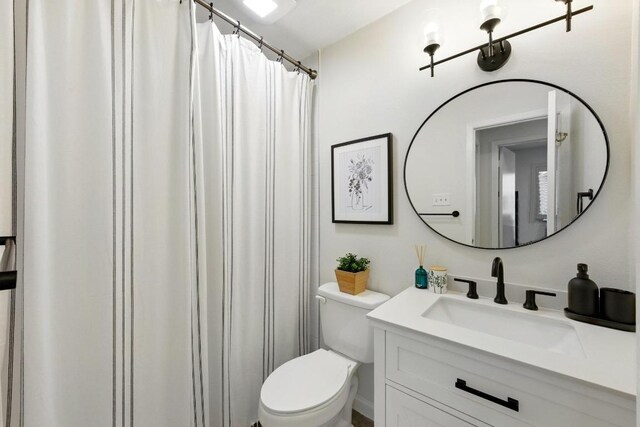 5202 Hedgewood Dr, Austin, TX 78745 - bathroom with toilet, vanity, and curtained shower