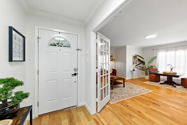 5202 Hedgewood Dr, Austin, TX 78745 - foyer entrance featuring light wood-style floors, baseboards, and ornamental molding