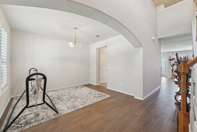 4013 Veiled Falls Dr, Pflugerville, TX 78660 - entrance foyer featuring arched walkways, baseboards, plenty of natural light, and dark wood-type flooring