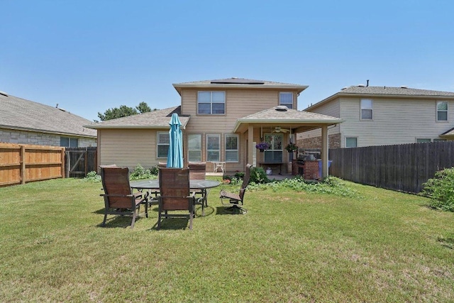 4013 Veiled Falls Dr, Pflugerville, TX 78660 - back of house featuring roof mounted solar panels, a patio area, outdoor dining area, and roof with shingles