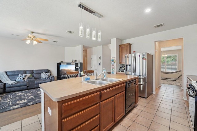 4013 Veiled Falls Dr, Pflugerville, TX 78660 - kitchen with a sink, appliances with stainless steel finishes, light countertops, a center island with sink, and recessed lighting