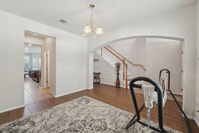 4013 Veiled Falls Dr, Pflugerville, TX 78660 - entryway with wood finished floors, arched walkways, baseboards, a chandelier, and stairway