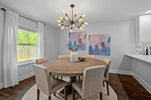 12420 Cassady Dr, Austin, TX 78727 - dining room featuring a chandelier, baseboards, and dark wood-style flooring