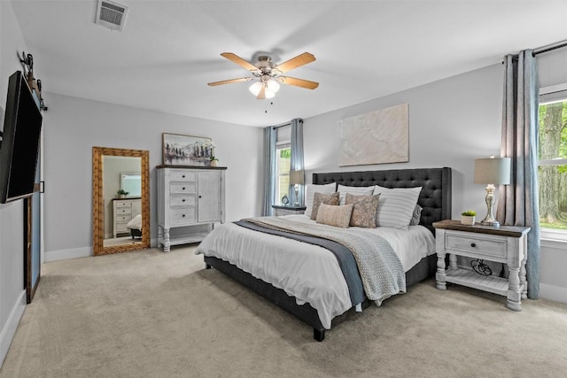 12420 Cassady Dr, Austin, TX 78727 - bedroom featuring multiple windows, light carpet, baseboards, and ceiling fan