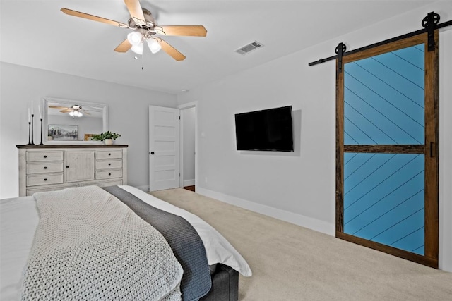 12420 Cassady Dr, Austin, TX 78727 - carpeted bedroom featuring a barn door, baseboards, and a ceiling fan