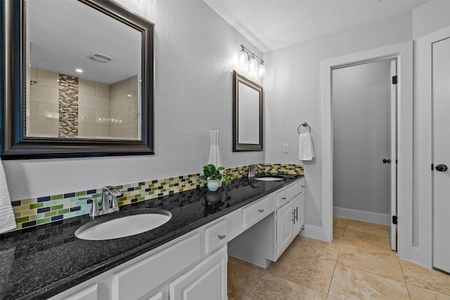 12420 Cassady Dr, Austin, TX 78727 - bathroom featuring double vanity, decorative backsplash, and baseboards